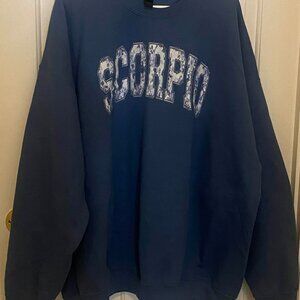 WOMEN'S GILDAN BLUE SWEATSHIRT with the word "SCORPIO" PRINTED ON FRONT